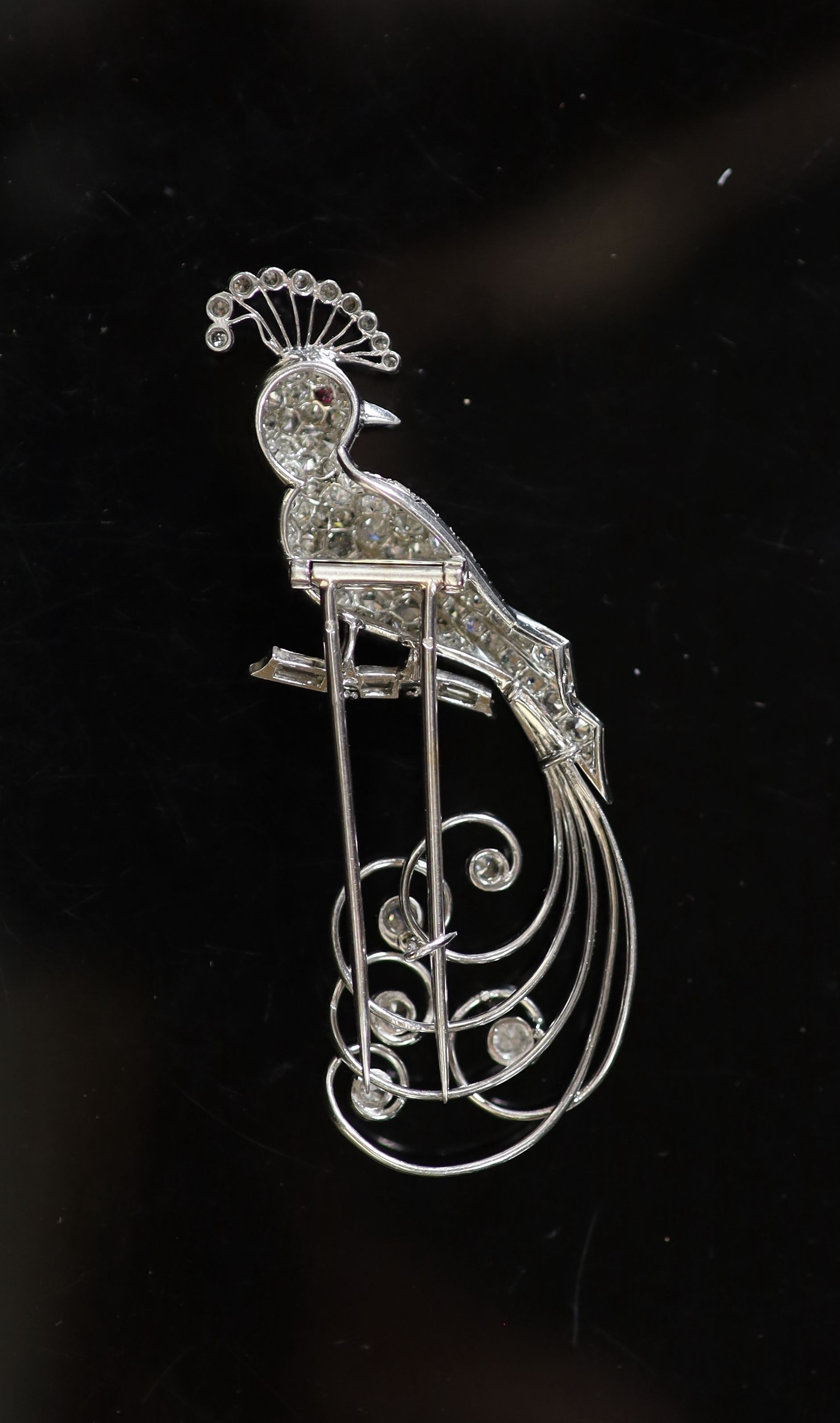 An early to mid 20th century French 18ct white gold and diamond encrusted 'bird of paradise' clip brooch